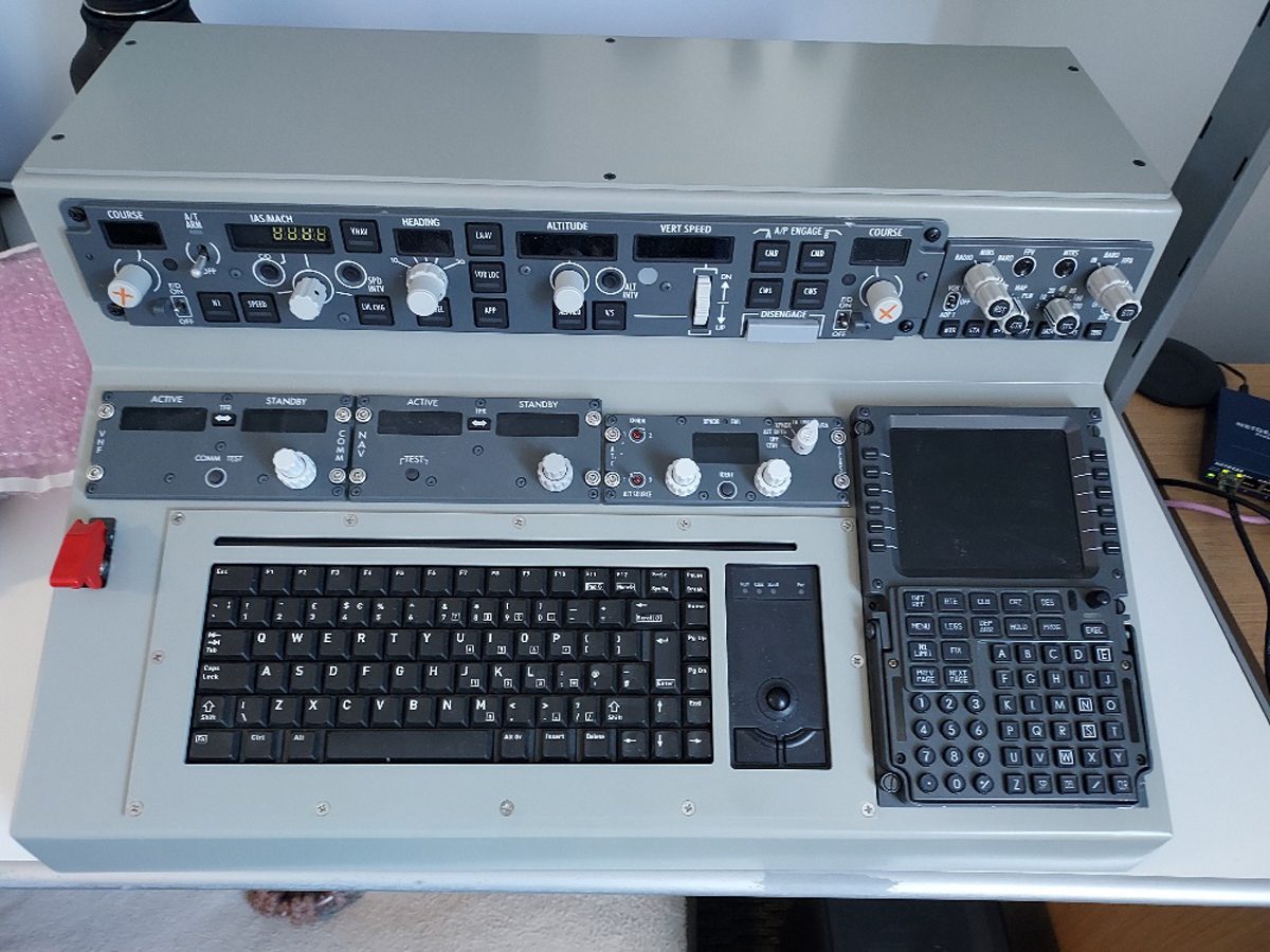 An assembled flight-deck panel set including an autopilot mode selector, radio control heads, a display unit and an integrated keyboard.